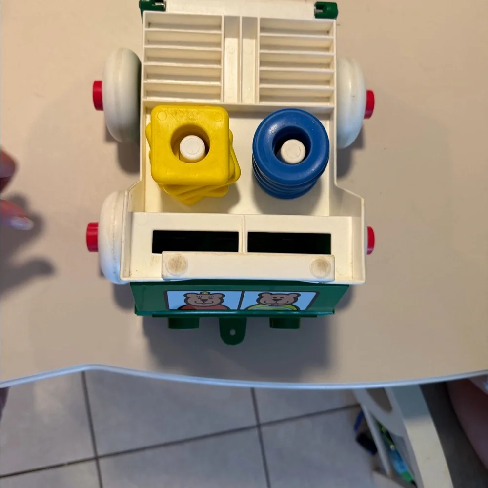 Johnson and‎ Johnson vintage stacking rings pull string truck toy with person